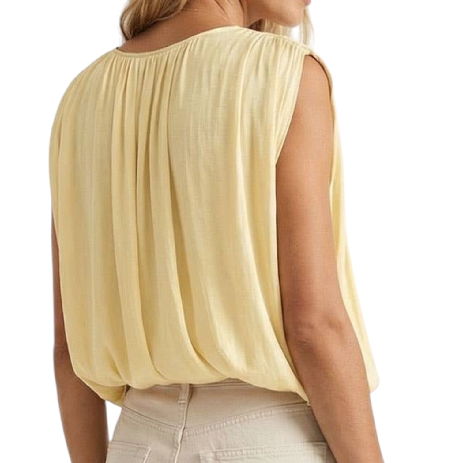 Light yellow sleeveless top worn by a person on a white background
