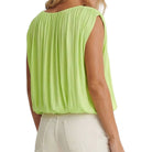 Light green sleeveless top worn by a person on a white background