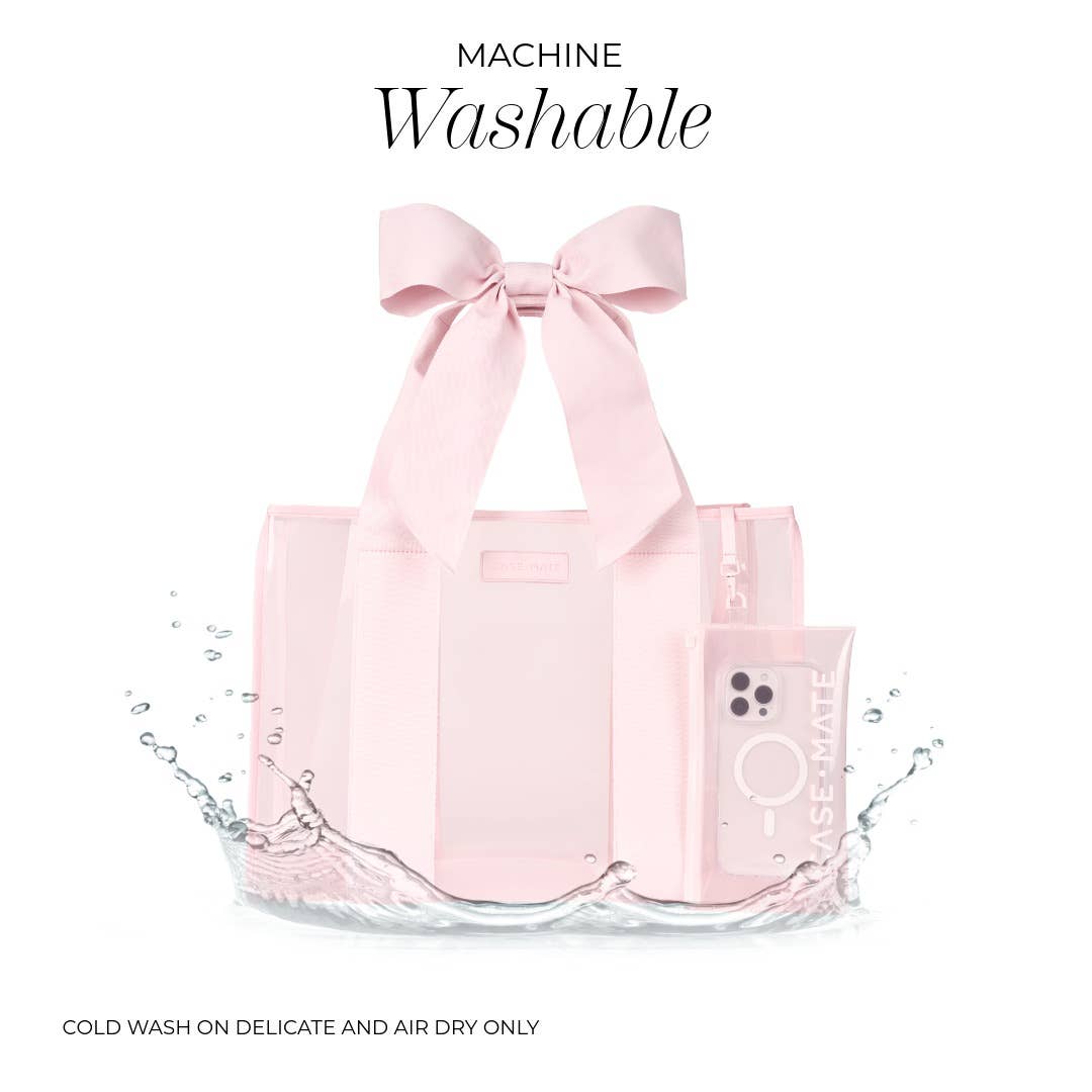 Pink tote bag with a bow on a white background, labeled 'Machine Washable'.