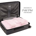 Black suitcase with pink folded clothes inside, labeled 'Designed to Fold Flat for Packing'.