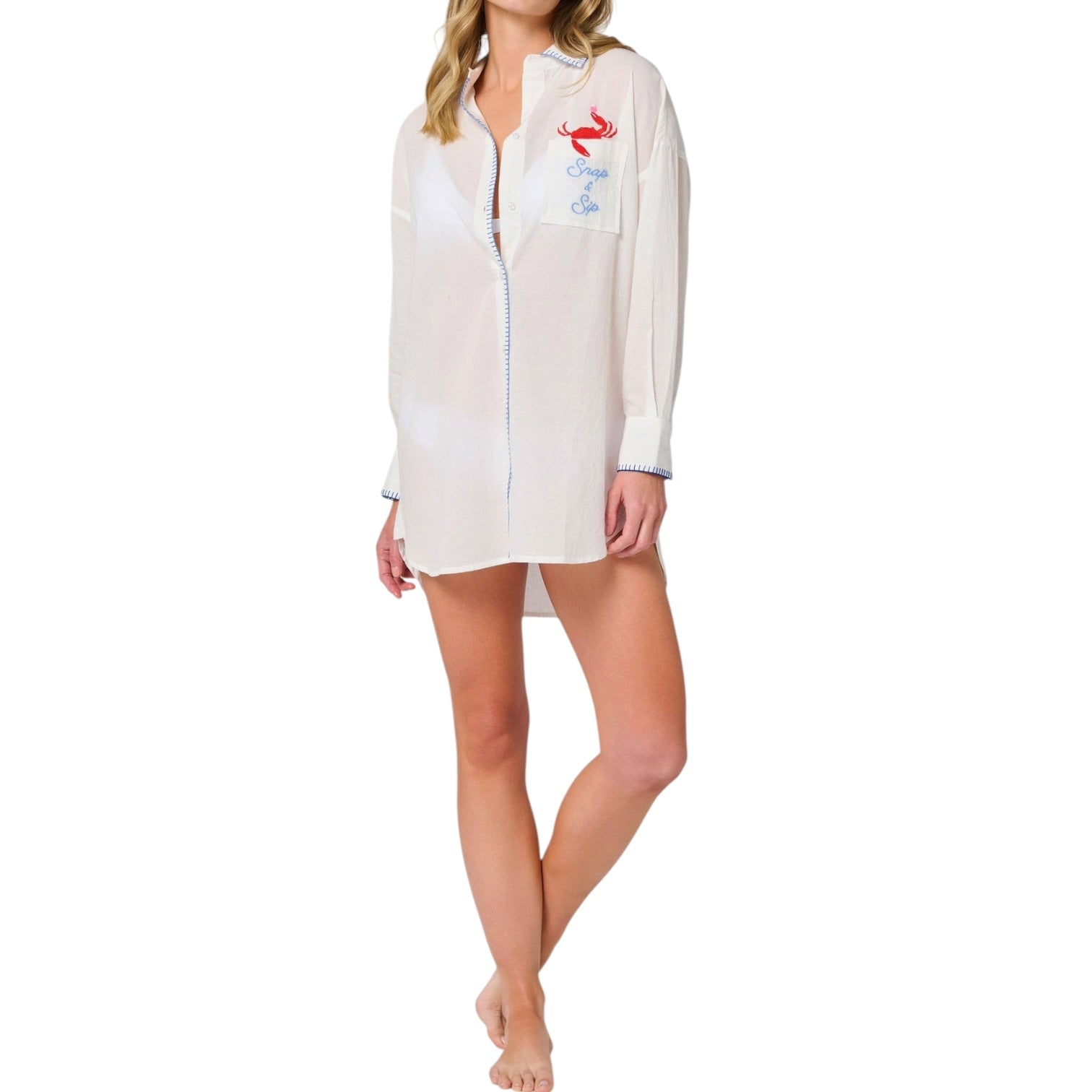 woman wearing white button down cover up with a crab with a wine glass coming out of the pocket that says "Snap & Sip" on white background.