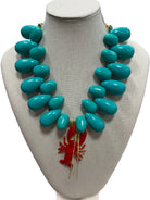 resin beaded necklace with lobster on white background.