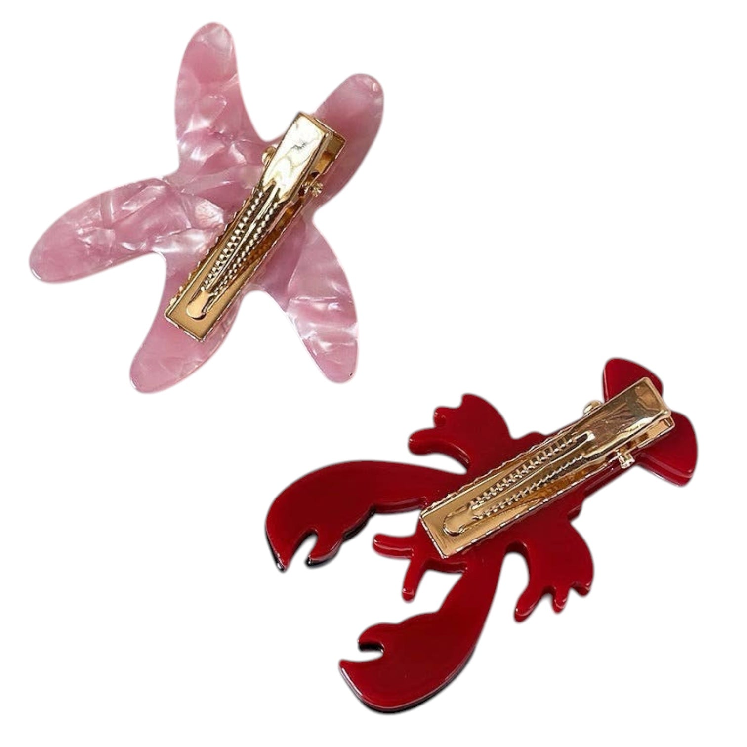 Two hair clips, one pink and one red, on a white background