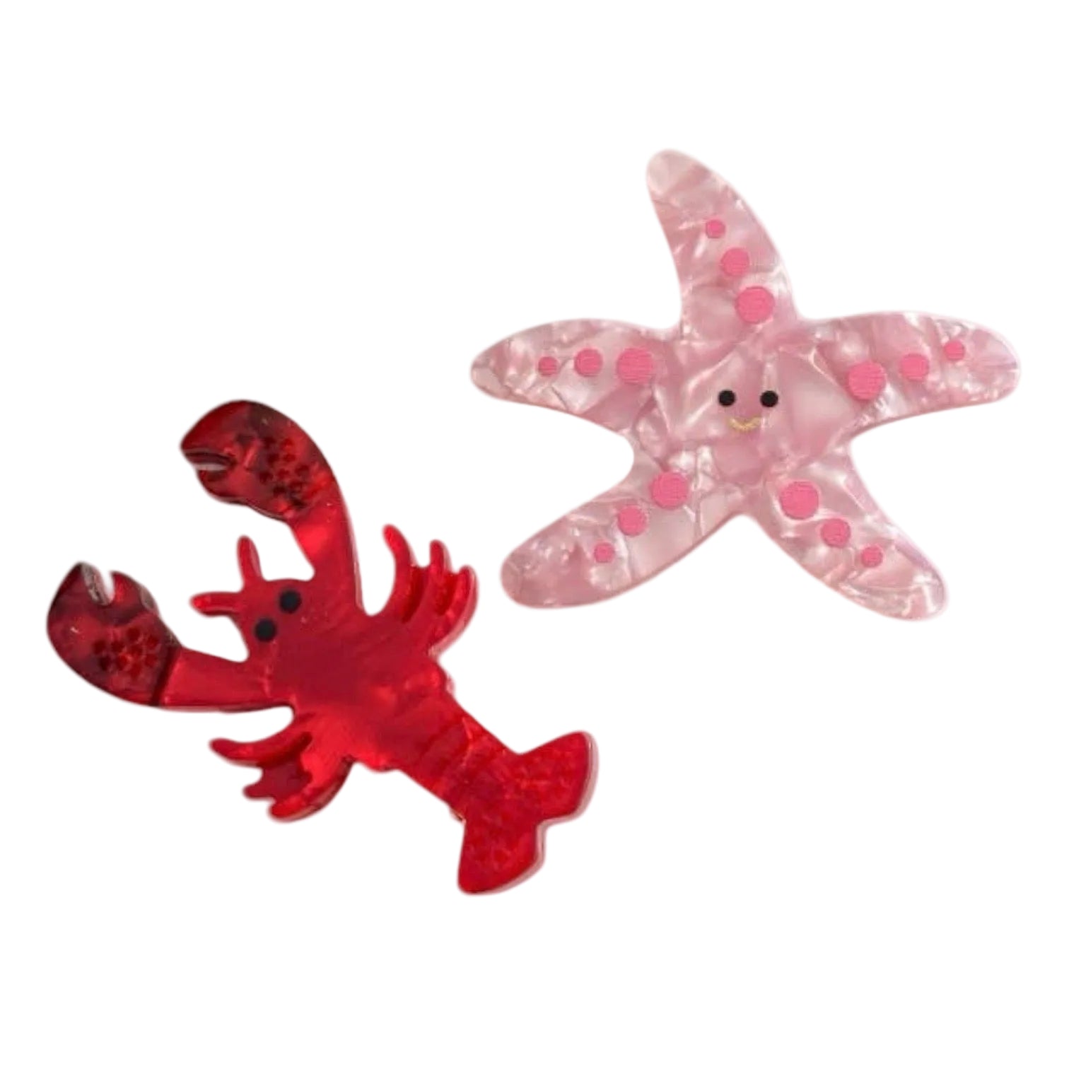 Red lobster and pink starfish toy on a white background
