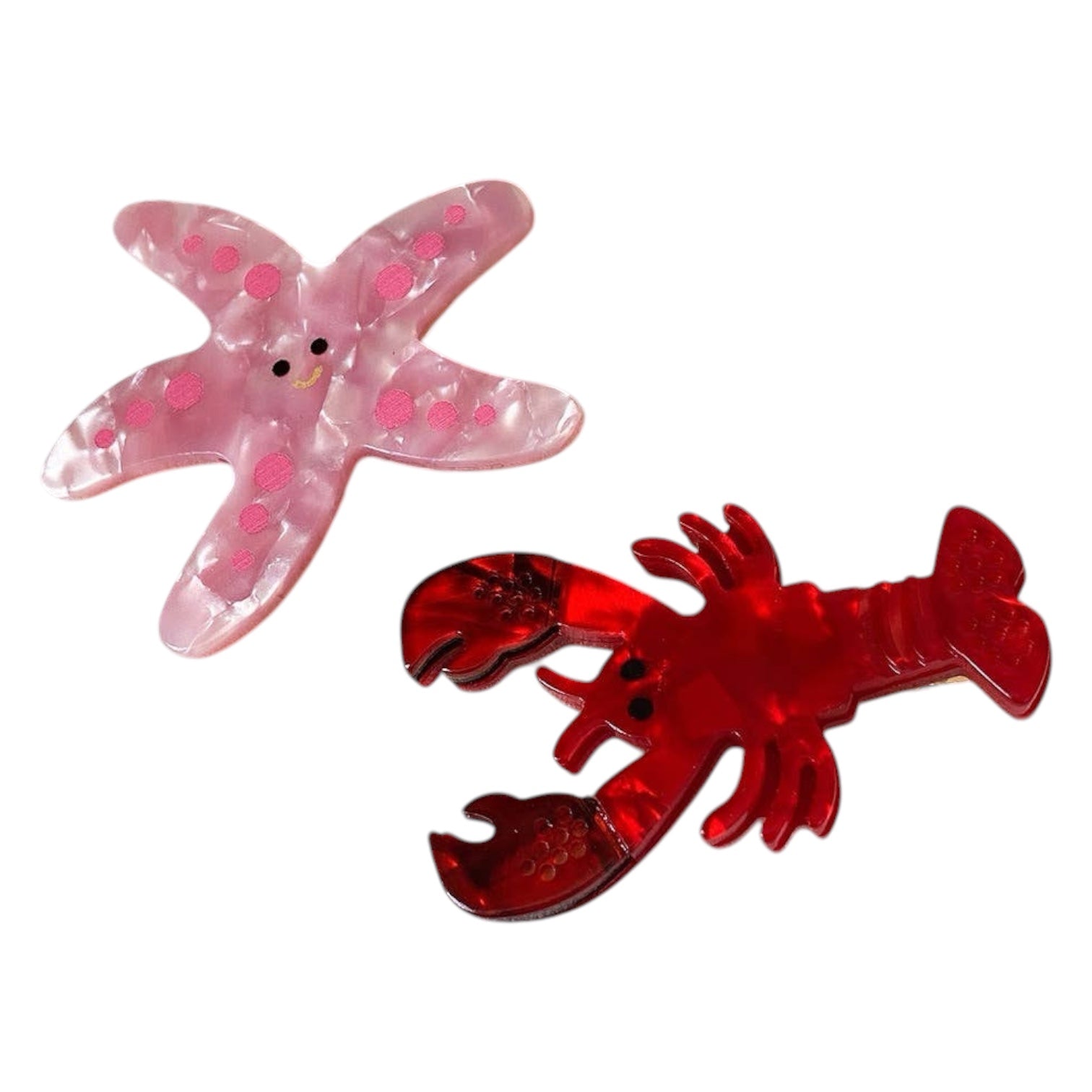 Pink starfish and red lobster hair clip on a white background