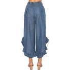 Person wearing chambray pants on a white background