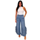 Person wearing a white tank top and chambray pants on a white background