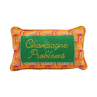 Pillow with 'Champagne Problems' text on a green background with orange border