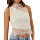 White lace top worn by a person on a white background