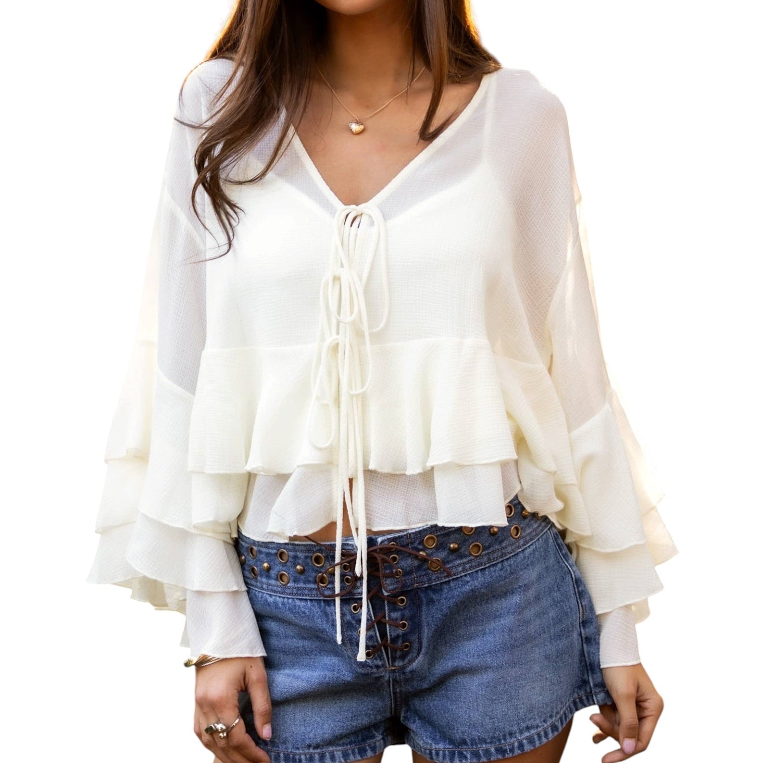 White ruffled blouse worn by a person on a white background