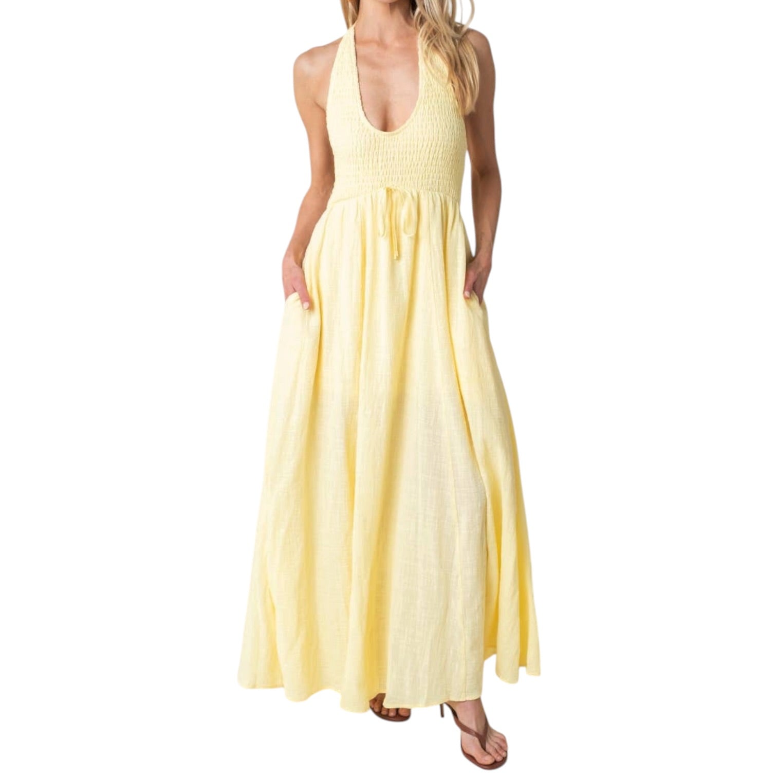 Woman wearing a yellow maxi dress on a white background
