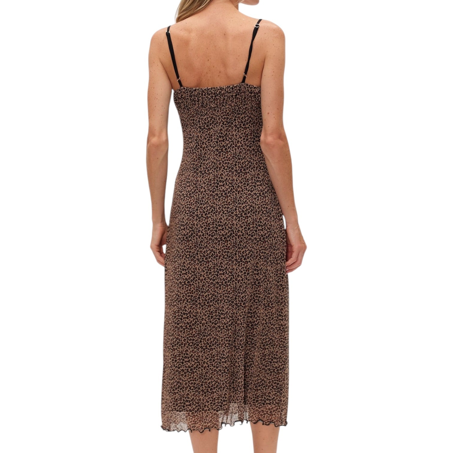 Woman wearing a leopard print slip dress on a white background