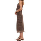 Woman wearing a brown patterned dress on a white background