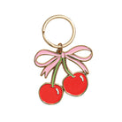 Keychain with red cherries and a pink bow on a white background