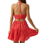 Red romper with a tiered skirt on a white background