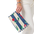 Hand holding a small pouch with cherry pattern on a white background