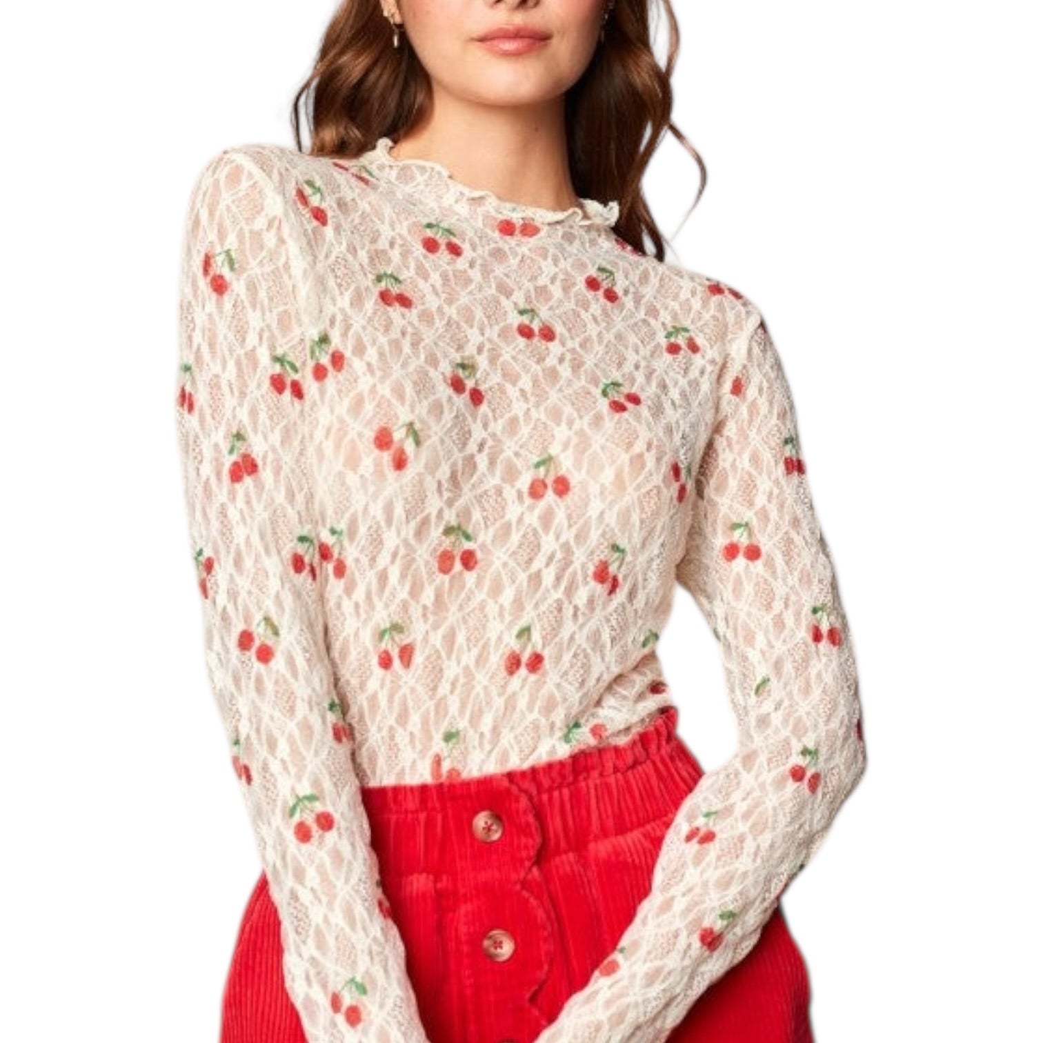 Woman wearing a lace top with cherry pattern and red pants on a white background