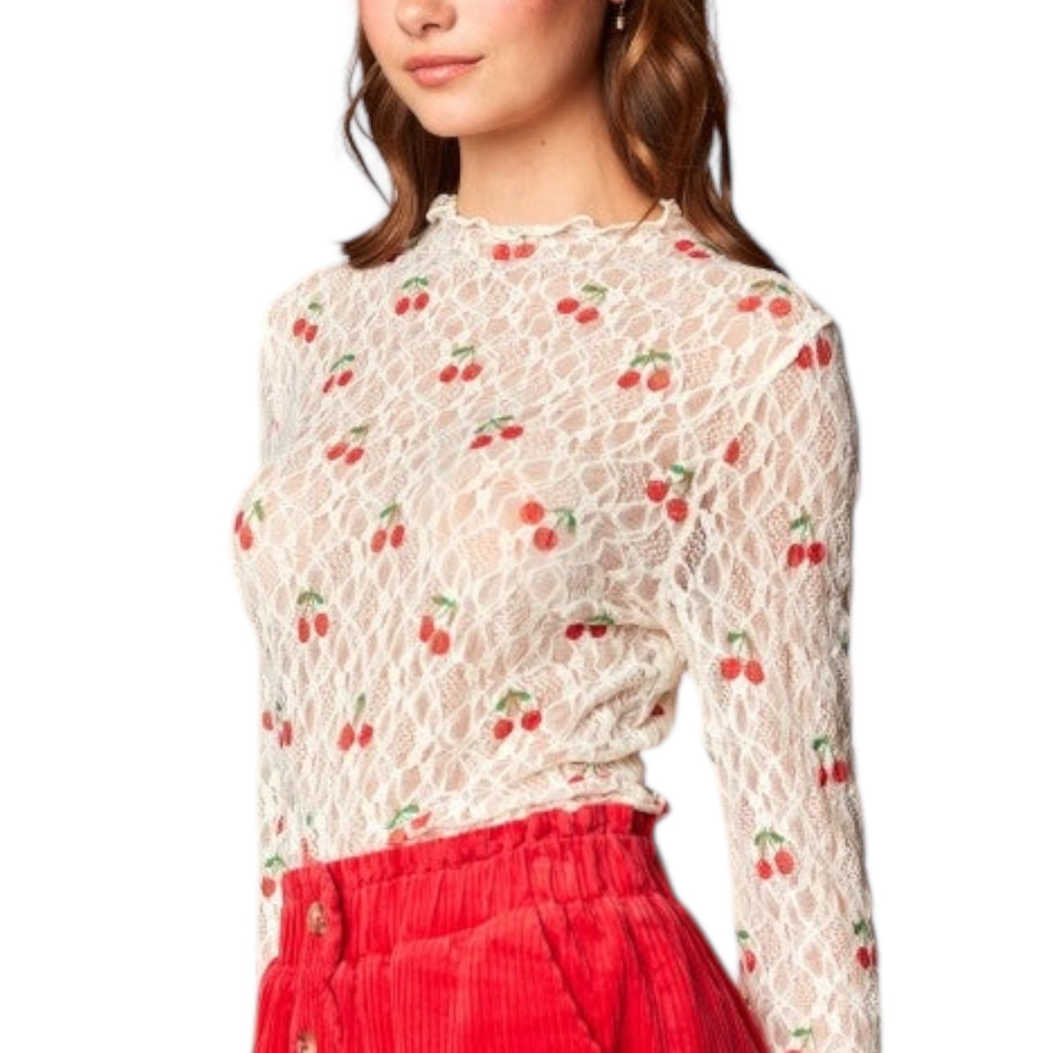 Woman wearing a lace top with cherry pattern and red pants on a white background