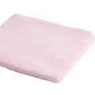 Folded pink blanket on a white background