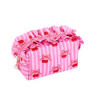 Pink striped cosmetic pouch with red cherry and bow patterns, featuring a ruffled top zipper closure and a small pearl charm.