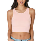 Woman wearing a light pink tank top on a white background