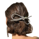 Hair clip with rhinestones in a person's hair on a white background