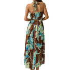 Woman wearing a floral dress with a brown background