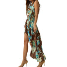 Woman wearing a floral dress with a brown base color on a white background