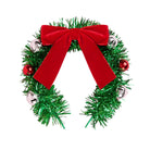 A festive Christmas headband made of green tinsel, decorated with a large red velvet bow, small red ornaments, and silver bells, shown on a plain white background.