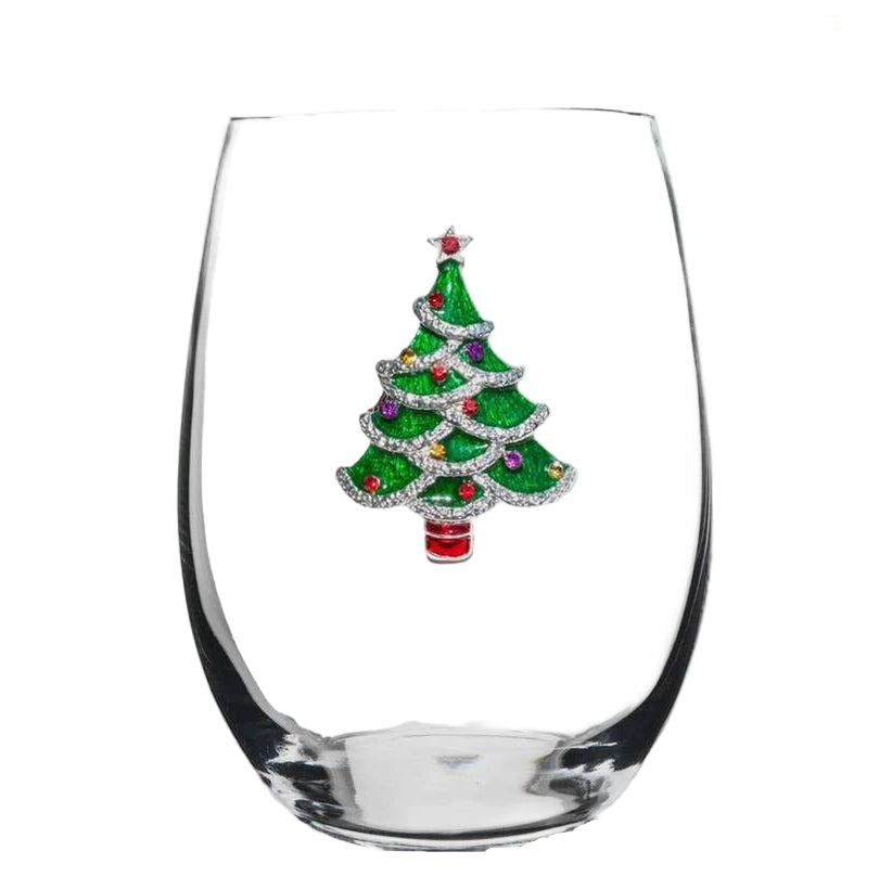 Clear glass wine glass with a decorative Christmas tree charm on a white background