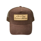 Brown trucker cap with a gold patch on a white background