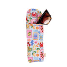 Colorful patterned sunglasses case with a pair of sunglasses peeking out on a white background