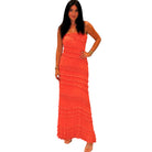 Woman wearing a coral strapless dress on a white background