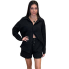 Woman wearing a black outfit on a white background