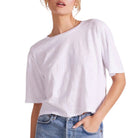 Person wearing a white t-shirt and blue jeans on a white background