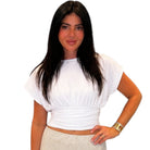 Woman wearing a white top and beige skirt on a white background