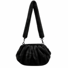 A black faux fur shoulder bag with a gathered, pleated body and a long, wide shoulder strap, shown against a plain white background.