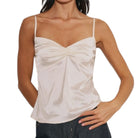 Woman wearing a cream tank top on a white background