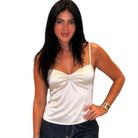 Woman wearing a cream tank top on a white background