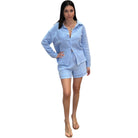 Woman wearing a light blue outfit on a white background