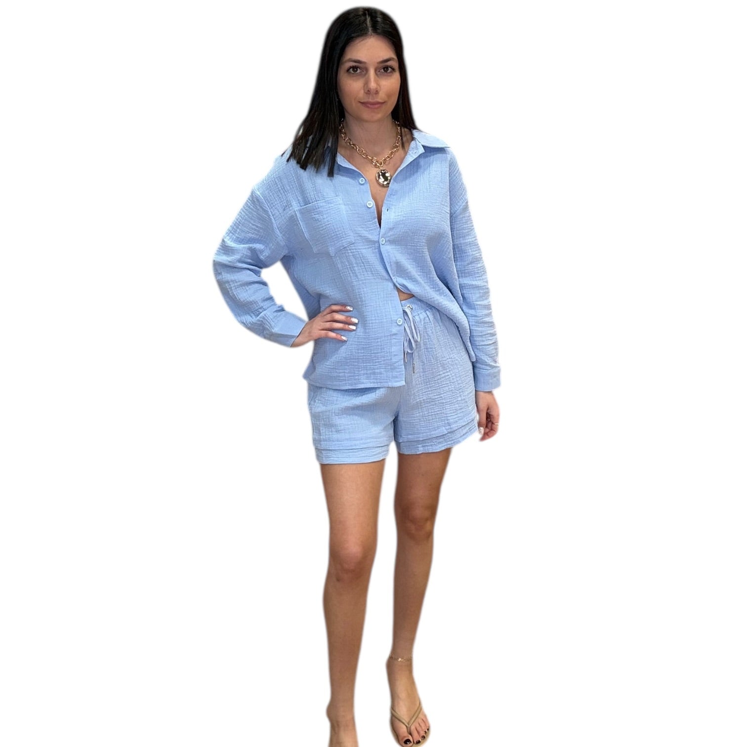 Woman wearing a light blue outfit on a white background