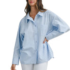 Woman wearing a blue and white striped shirt on a white background