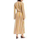 Woman wearing a long, patterned dress on a white background