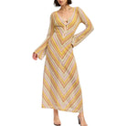 Woman wearing a long, patterned dress with a white background
