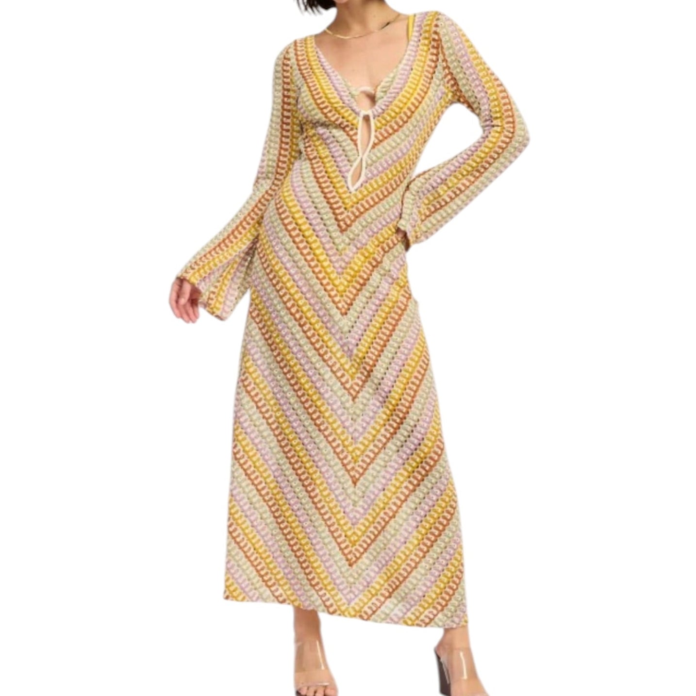 Woman wearing a long, patterned dress with a white background