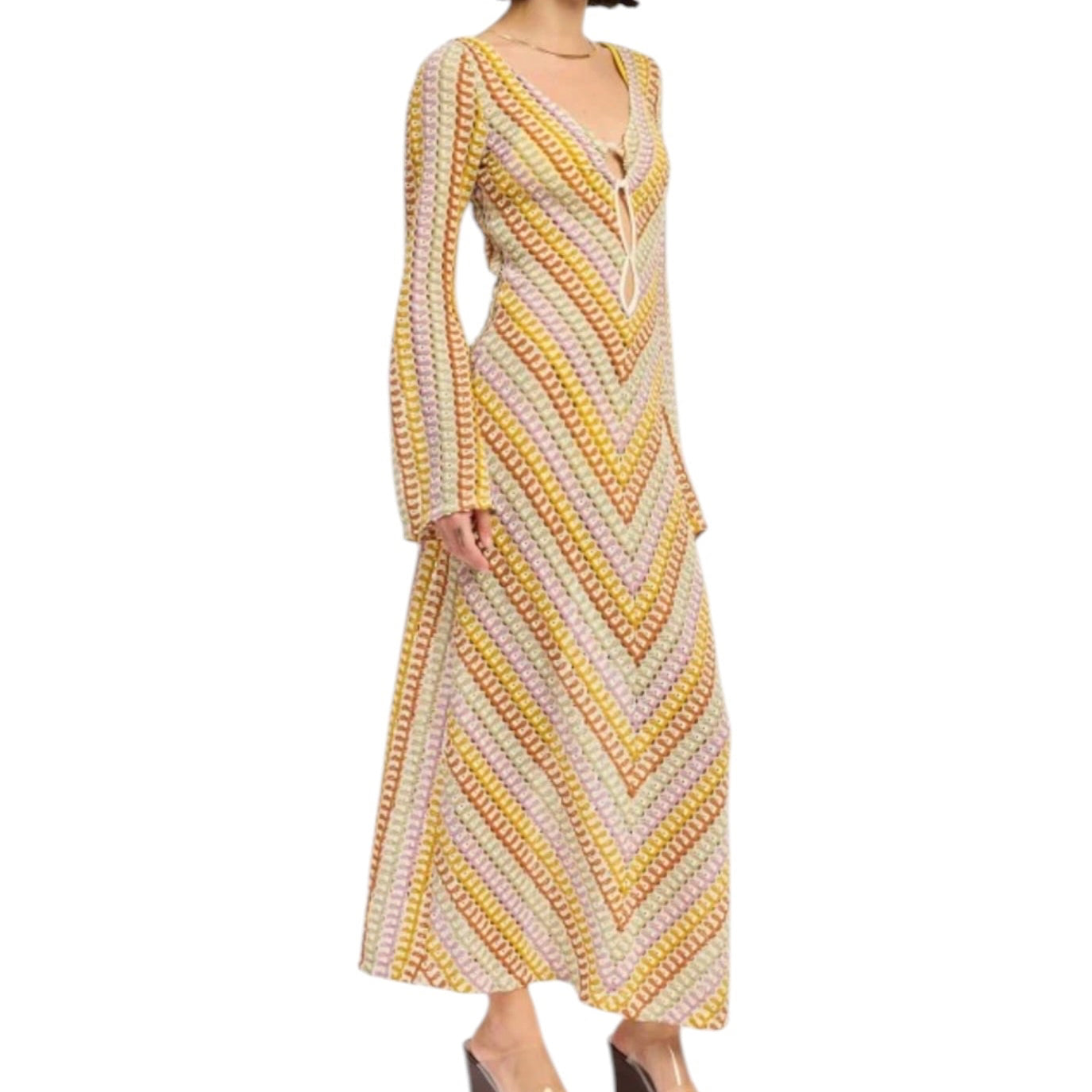 Woman wearing a long, patterned dress on a white background