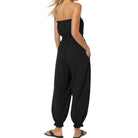 Black strapless jumpsuit worn by a person on a white background