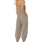 woman wearing taupe jumpsuit on white background