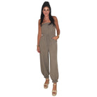 woman wearing taupe jumpsuit on white background