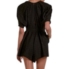 Black patterned romper on a white background